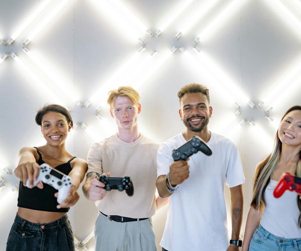 Diverse group of people smiling in a bright yoga studio.